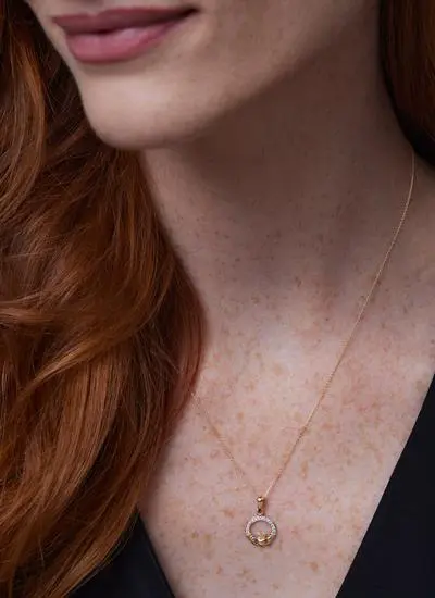 Close up shot of red haired model wearing 14ct Gold Vermeil Claddagh Pendant with Cubic Zirconia